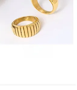 Macro detail of gold-plated twisted croissant ring with a polished ribbed texture
