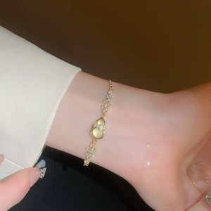 Elegant gold hulu bracelet with cat eye stone and cubic zirconia for women