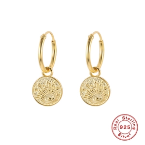 Close-up of golden S925 sterling silver hoop earrings with sunburst moon phase pendants