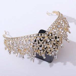 Detailed close-up of a luxurious gold bridal crown with shimmering clear crystals