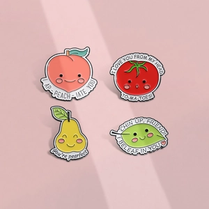 Cartoon fruit and plant enamel pins featuring peach, tomato, pear, and leaf motifs
