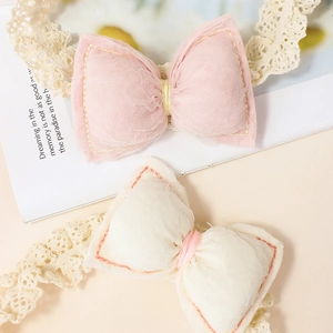 Handmade elastic lace baby headbands with soft fabric bows in pink and cream colors