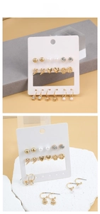 Detail of assorted gold-tone pearl and heart stud earrings set on a display card