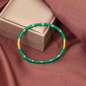 Macro detail of green enamel bamboo bracelet with gold-plated stainless steel clasp