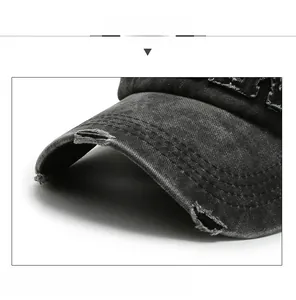 Macro shot of the distressed brim details on a washed cotton baseball cap with torn edges