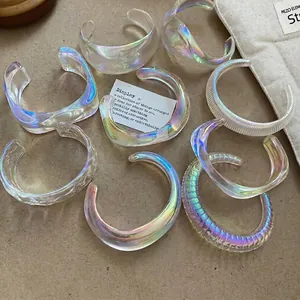 Iridescent acrylic geometric bangles featuring iridescent glow and colorful textures