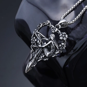 Detailed close-up of retro silver angel fairy heart pendant with floral texture