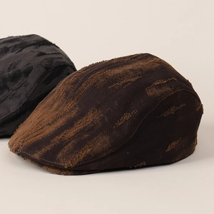 Detail of distressed canvas fabric texture and frayed edges on vintage ivy flat caps