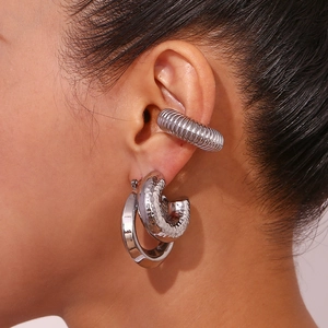 Silver hollow chunky hoop earrings and textured ear cuff set worn by female model
