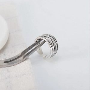 Close-up of S925 sterling silver hallmark on multilayered braided wrap open ring