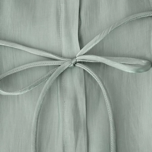 Elegant light green satin shirt with stylish waist tie detail and silky glossy finish