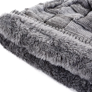 Detailed close-up showing thick grey knitted fabric and soft warm fleece lining of the hat