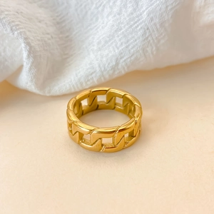 Macro shot of gold hollow cuban link chain ring with polished stainless steel finish