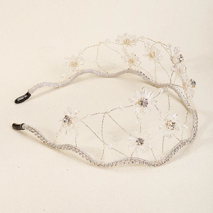 Detail of silver mesh headband featuring intricate crystal flowers and sparkling rhinestones