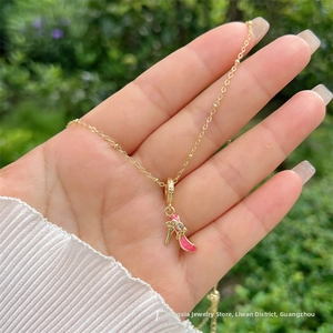 Dettaglio di una collana placcata oro 18K con ciondolo a tacco rosa e pietre di zirconi