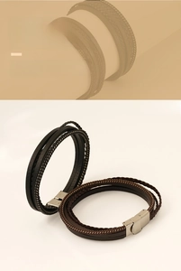 Detail of multi-layer braided leather bracelet with brushed metal magnetic clasp