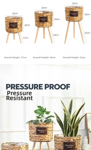 Set of woven seagrass plant pots with wooden tripod legs in three different sizes