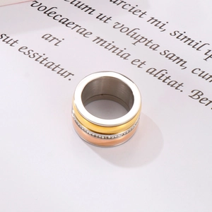 Detailed top view of tri-color stacked rings in silver, gold, and rose gold with pavé zircon