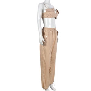 Detail of khaki two-piece set with cropped utility vest and drawstring cargo pants
