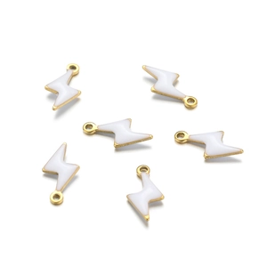 Macro view of six white enamel lightning bolt pendants with gold frames for jewelry