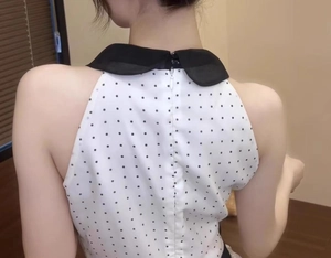 Detailed back view of a polka dot sleeveless top with Peter Pan collar and zipper