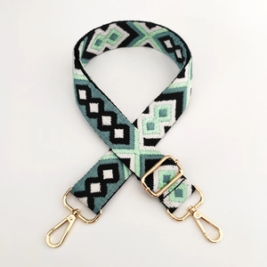 Detail of adjustable geometric embroidered wide strap with premium gold metal hooks