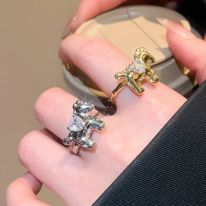Detailed view of horse-shaped open rings with heart-shaped zircon on model hand