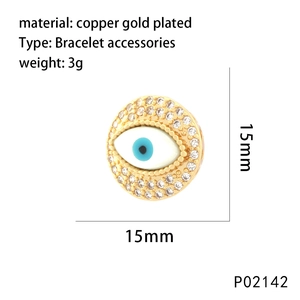 Detail of 15mm gold-plated copper evil eye pendant with clear zircons and enamel