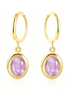 Detailed macro view of vintage oval lavender zircon pendants on gold hoops for women