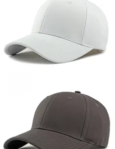 Detail view of cotton baseball caps in white and grey showing fabric texture and stitching