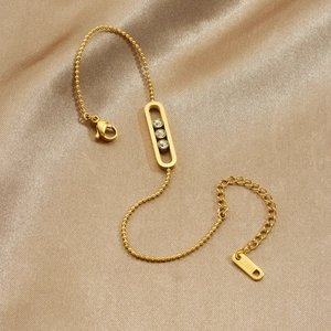 Gold plated stainless steel bracelet with three sliding diamonds on champagne silk