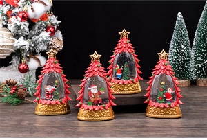 Detailed view of four festive Christmas crystal balls with vintage gold embossed bases