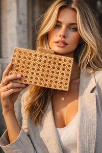 Detail of natural rattan evening bag showing hexagonal weaving and wooden clasp closure