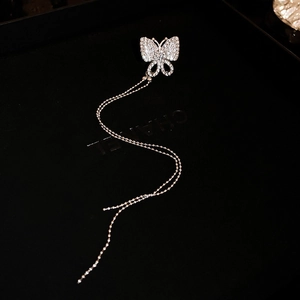 Detailed view of silver butterfly earring with sparkling cubic zirconia and long tassels