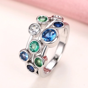 Polished silver stacked ring set with blue, green and white round-cut gemstones