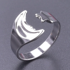 Close-up of adjustable stainless steel ring featuring celestial moon and star design