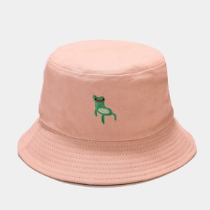 Detailed embroidery of a green cartoon frog on a pink cotton canvas bucket hat surface