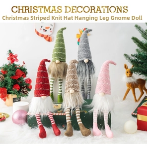 Close-up of five Christmas gnomes with striped legs and knit hats on snowy decor