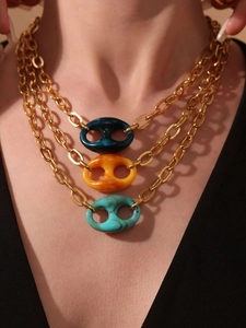 Macro-opname van de gelaagde gouden ketting met hars hangers gedragen om de hals