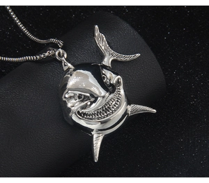 Detailed view of silver shark pendant in polished stainless steel with sharp fin details