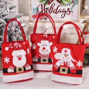 Three Christmas plush gift bags featuring Santa, Reindeer and Snowman in a cozy holiday setting