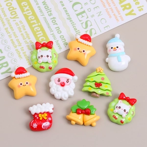 Assorted Christmas resin charms featuring Santa, snowman, and cats on a beige desk