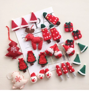 Handmade felt Christmas ornaments featuring reindeer and trees on vintage paper background