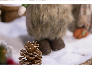 Close-up of brown plush Christmas doll texture with decorative pine cones at the base