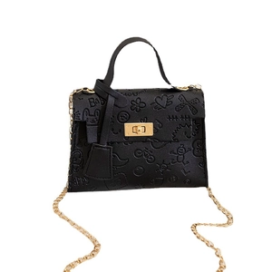 Black fashion Kelly style handbag with cartoon embossed patterns and gold chain strap