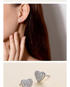 Detailed close-up and model view of silver heart-shaped stud earrings with pavé crystals
