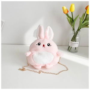 Close-up of pink plush rabbit crossbody bag with golden chain and embroidery details