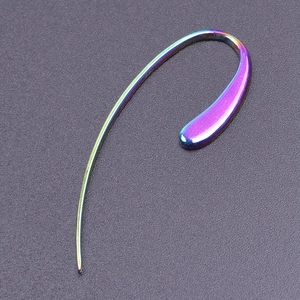 Macro shot of iridescent 304 stainless steel ear wire with smooth curved metal surface