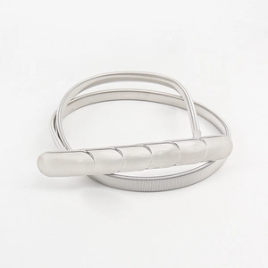 Detailed close-up of a silver elastic spring belt with a modern metal buckle closure