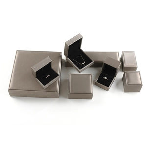 Brushed metallic jewelry box collection with black velvet interior for rings and necklaces